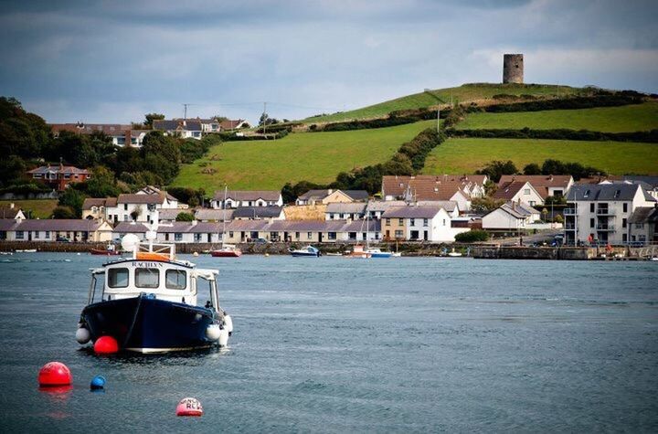 BOATS MOORED IN RIVER