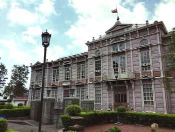 Low angle view of building against cloudy sky