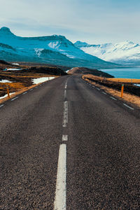 Road leading towards snowcapped mountain