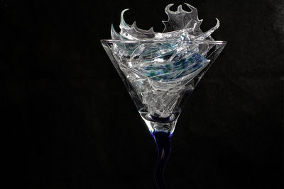 Close-up of drink in glass against black background