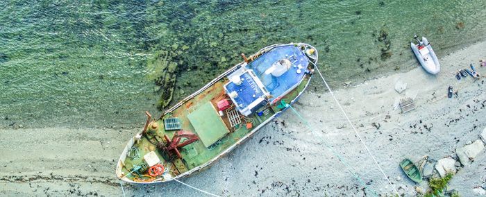 High angle view of abandoned boat moored at beach