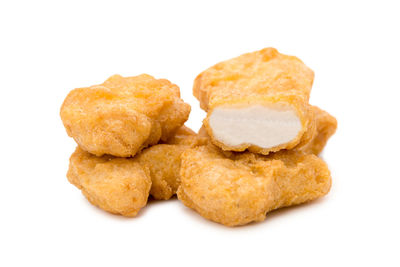 Close-up of bread in plate against white background