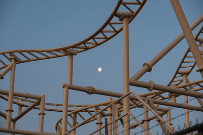 Low angle view of rollercoaster against clear sky