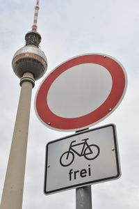 Low angle view of road sign against sky