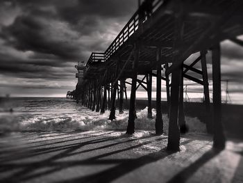 Pier on sea at sunset