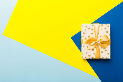 High angle view of gift box on blue background