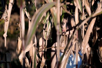 Portrait of young woman with plants at night