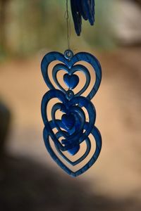 Close-up of heart shape hanging on metal