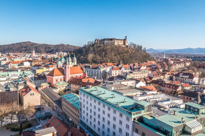 High angle view of townscape against clear blue sky