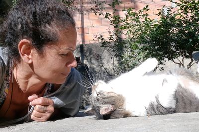 Portrait of woman looking at cat