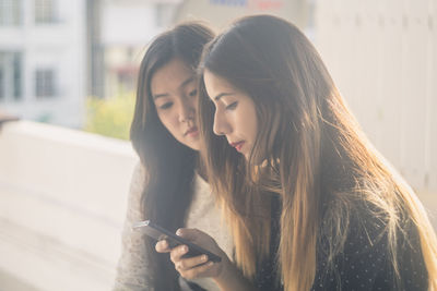 Young women using mobile phone