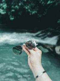 Midsection of person holding shell