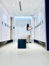 Woman standing in corridor of building