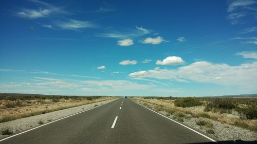 Scenic view of road against blue sky