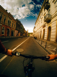 Man riding bicycle on road in city