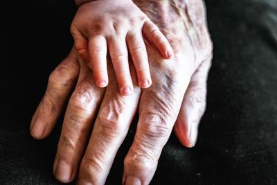 Close-up of hands touching feet