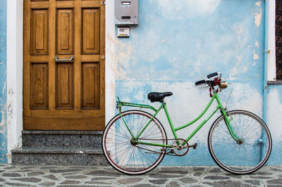 Bicycle against closed door of building