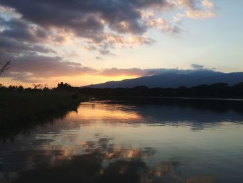 Scenic view of lake at sunset