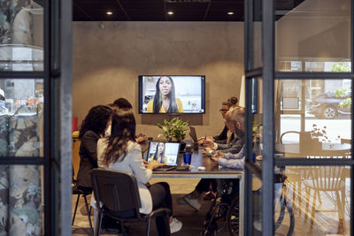 Multiracial business team discussing through virtual meeting at creative office