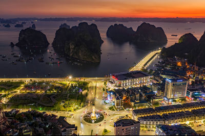 High angle view of city lit up at night