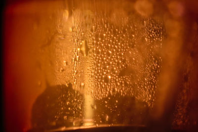 Close-up of wet glass window during rainy season