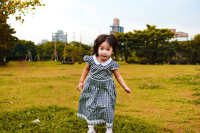 Portrait of girl standing on field