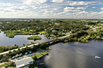 High angle view of river amidst trees against sky