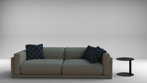 Empty sofa against white wall at home