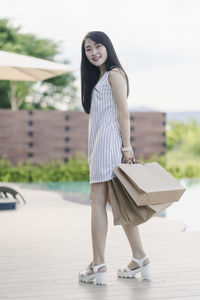 Portrait of young woman standing outdoors