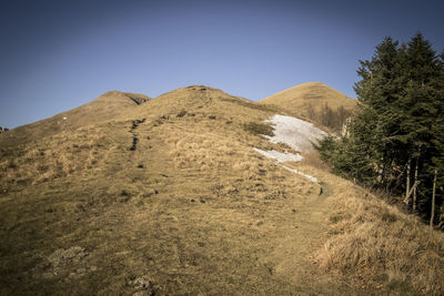 Scenic view of mountains against clear blue sky