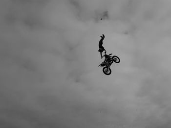 Low angle view of person skateboarding against sky