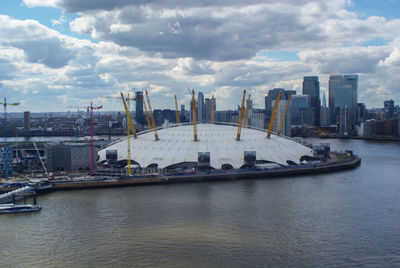 View of cityscape against cloudy sky