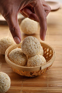 Indian food chaulai ke ladoo - hand picking up sweet balls eaten during fasting navratri