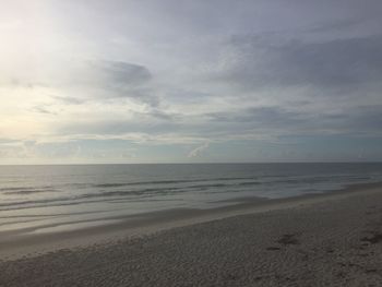 View of beach against cloudy sky