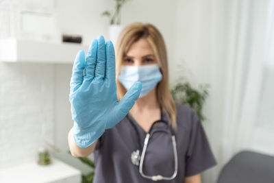 Portrait of young woman wearing protective mask