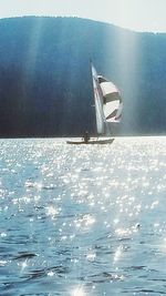 Sailboat in sea against sky