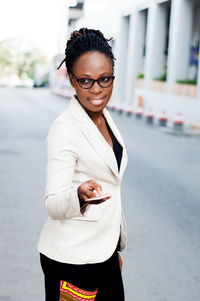 Young businesswoman giving a credit card to someone.