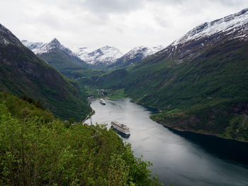 Scenic view of river amidst mountains against sky