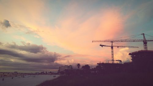 Silhouette cityscape against sky during sunset