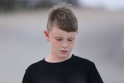 Portrait of boy looking away outdoors