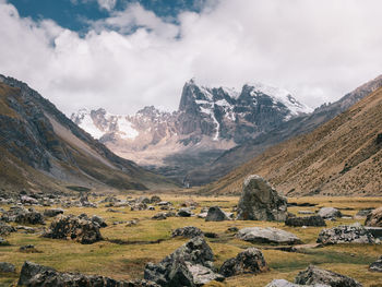 Scenic view of mountains against cloudy sky