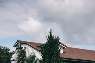 Low angle view of house and building against sky