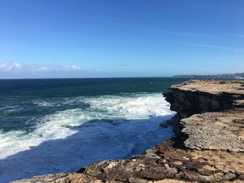 Scenic view of sea against clear blue sky