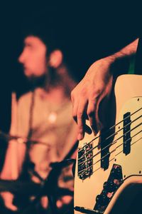 Close-up of man playing guitar