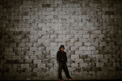 Rear view of man standing against wall