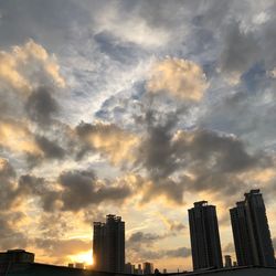 Low angle view of buildings against sky during sunset