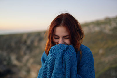 Portrait of woman standing on land against sky during winter