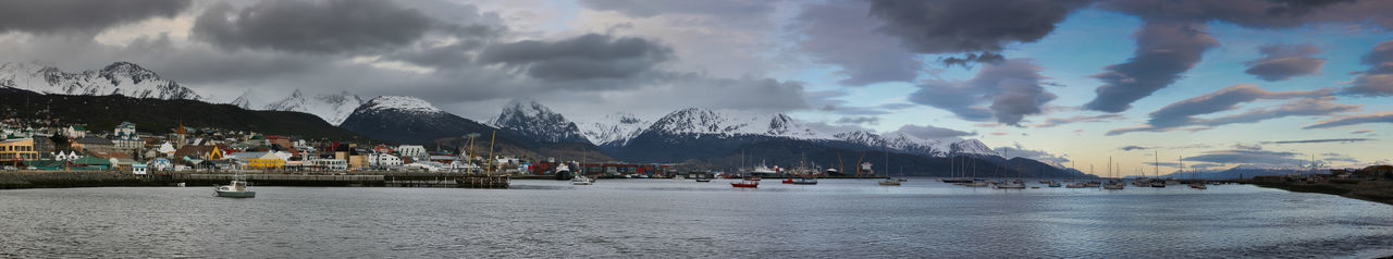 Panoramic view of buildings by sea against sky