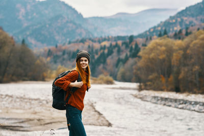 Young woman standing on snow covered mountain