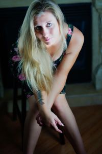 Portrait of young woman sitting at home